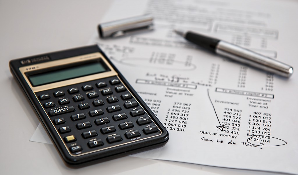 calculator and pen showing value acceleration