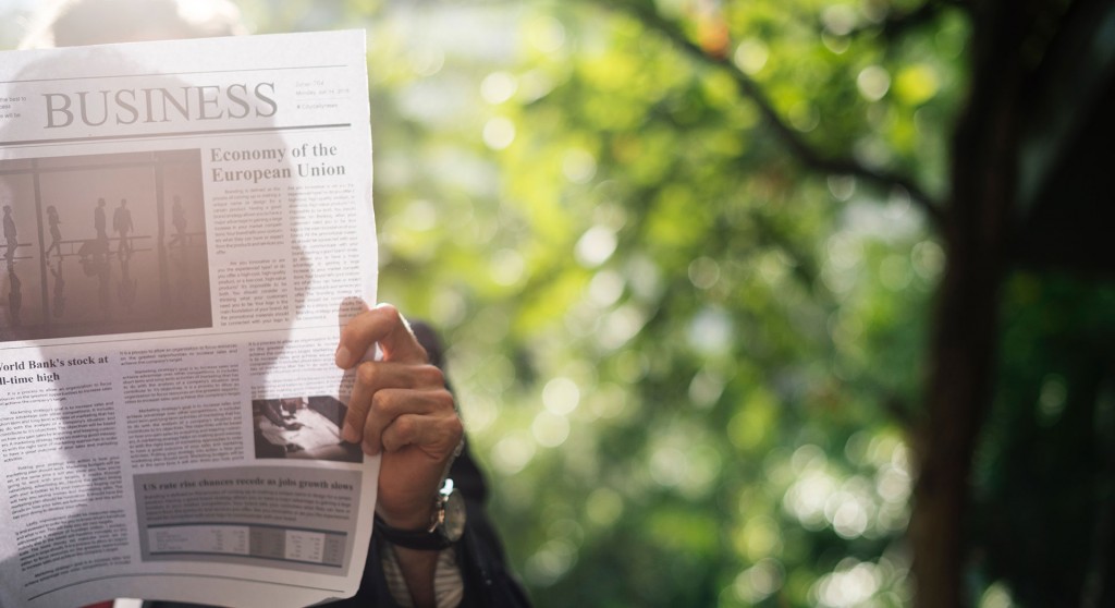 Man holding business newspaper