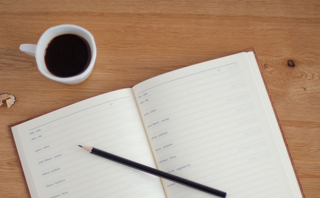 Notebook with pencil and a cup of coffee