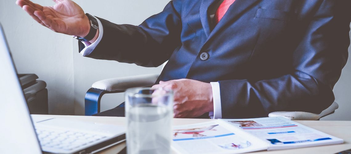 Business man in a dark blue suit at a desk
